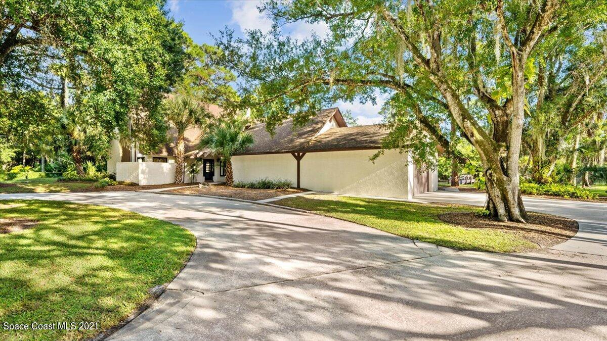 4455 Lake Washington Road Melbourne, FL 32934 - Photo 5 of 53 a view of street with large trees