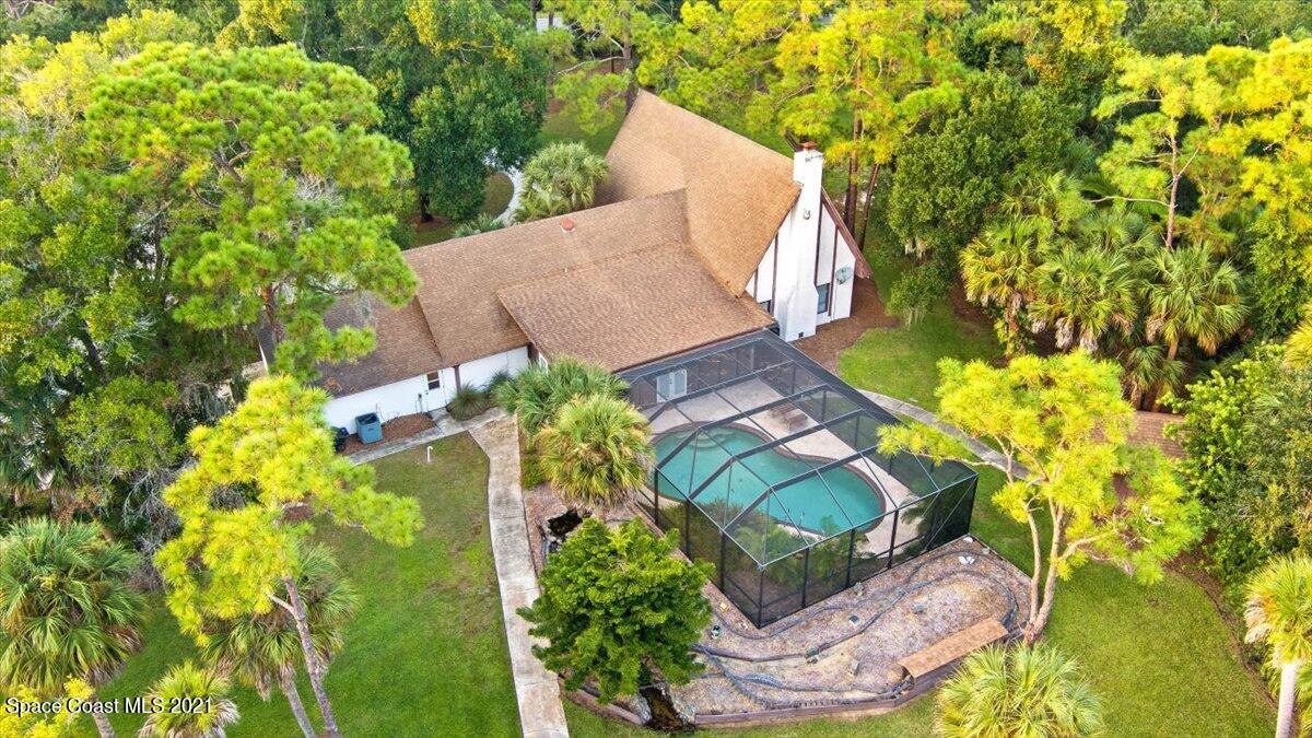 4455 Lake Washington Road Melbourne, FL 32934 - Photo 6 of 53 an aerial view of a house with a yard and garden