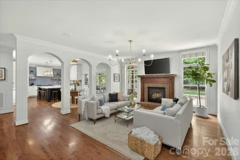 a living room with furniture a fireplace and a large window