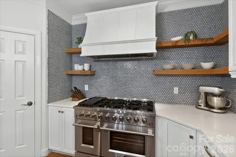 a kitchen with stainless steel appliances a stove and cabinets