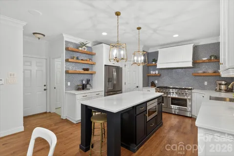 a kitchen with a sink stove and refrigerator