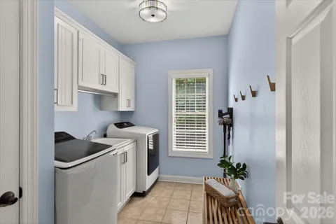 a kitchen with stainless steel appliances white cabinets and a window