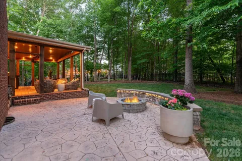 a backyard of a house with table and chairs
