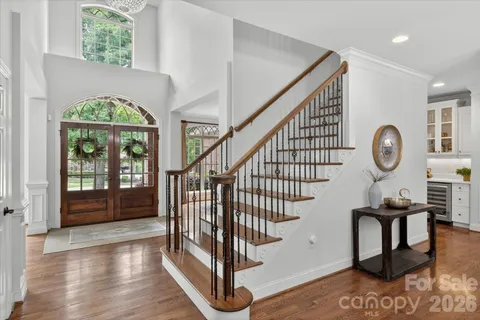 a view of entryway and hall with wooden floor