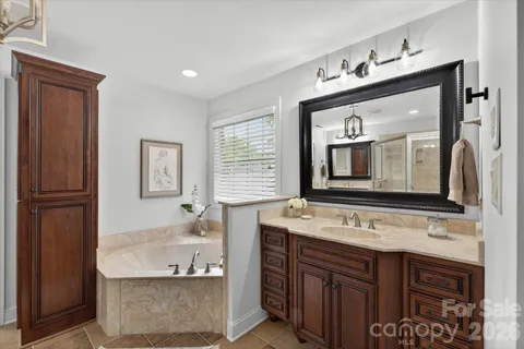 a bathroom with a bathtub sink and mirror