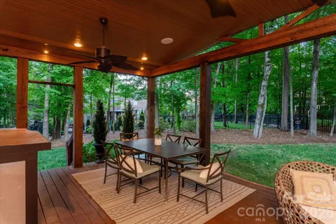 a view of a patio with a table chairs and a backyard
