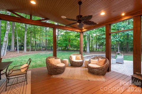 a view of a patio with a table chairs and a backyard