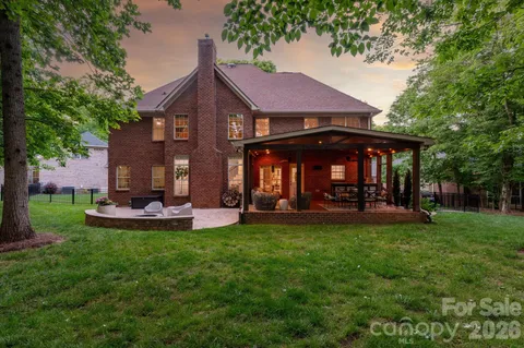 a view of a house with patio and a yard