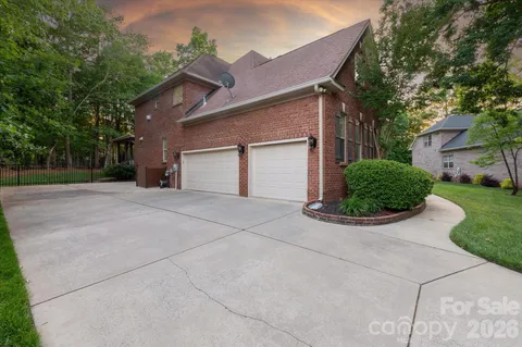 a view of a house with a yard and garage
