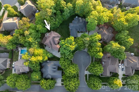 an aerial view of a house with a yard and garden