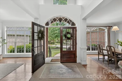 a view of an entryway with wooden floor and windows