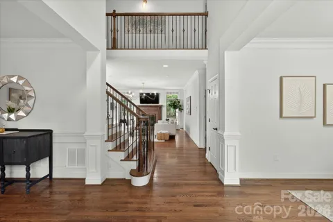 a view of entryway and hall with wooden floor