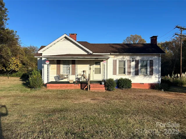 a view of a house with backyard porch and sitting area