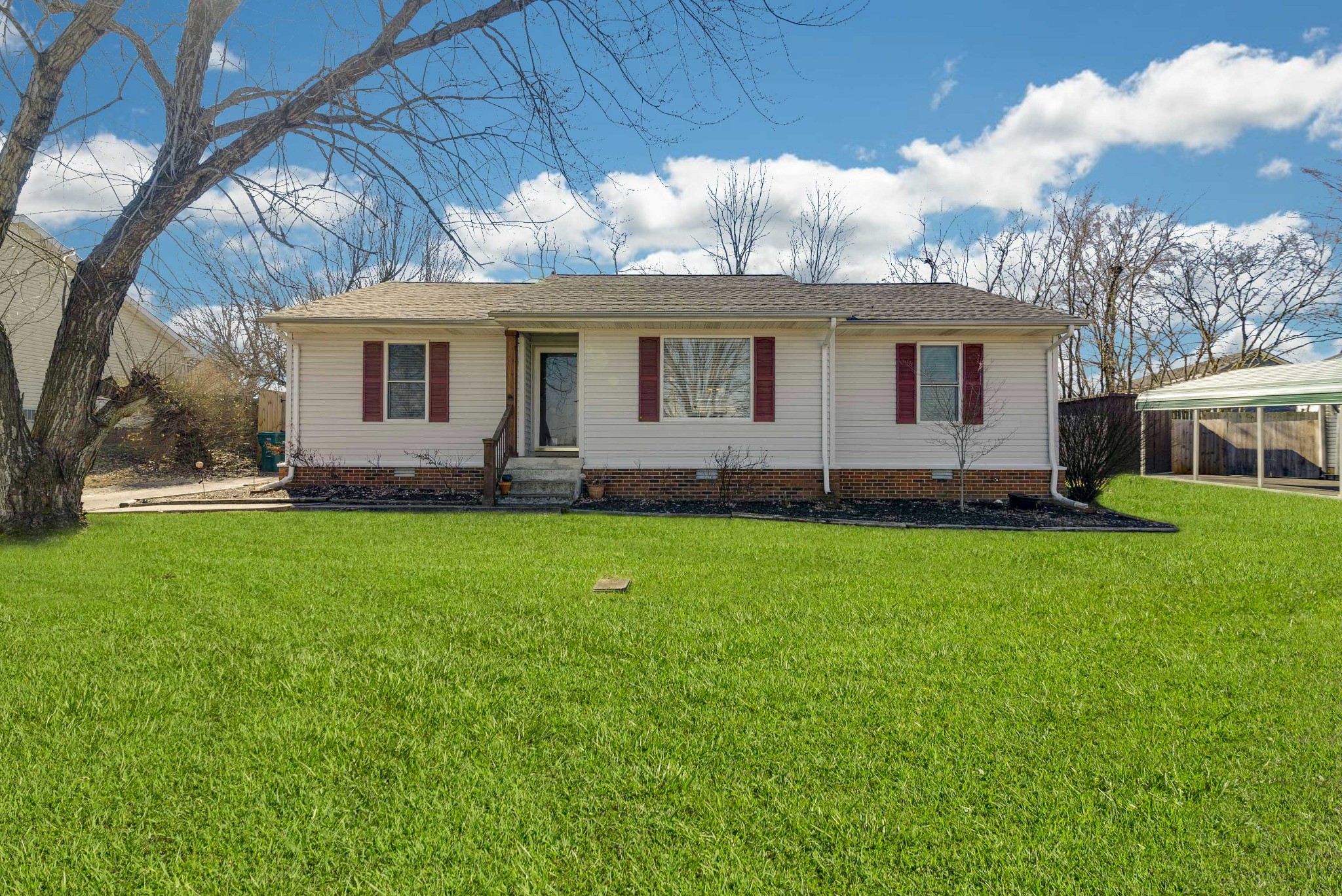 a front view of house with yard and green space