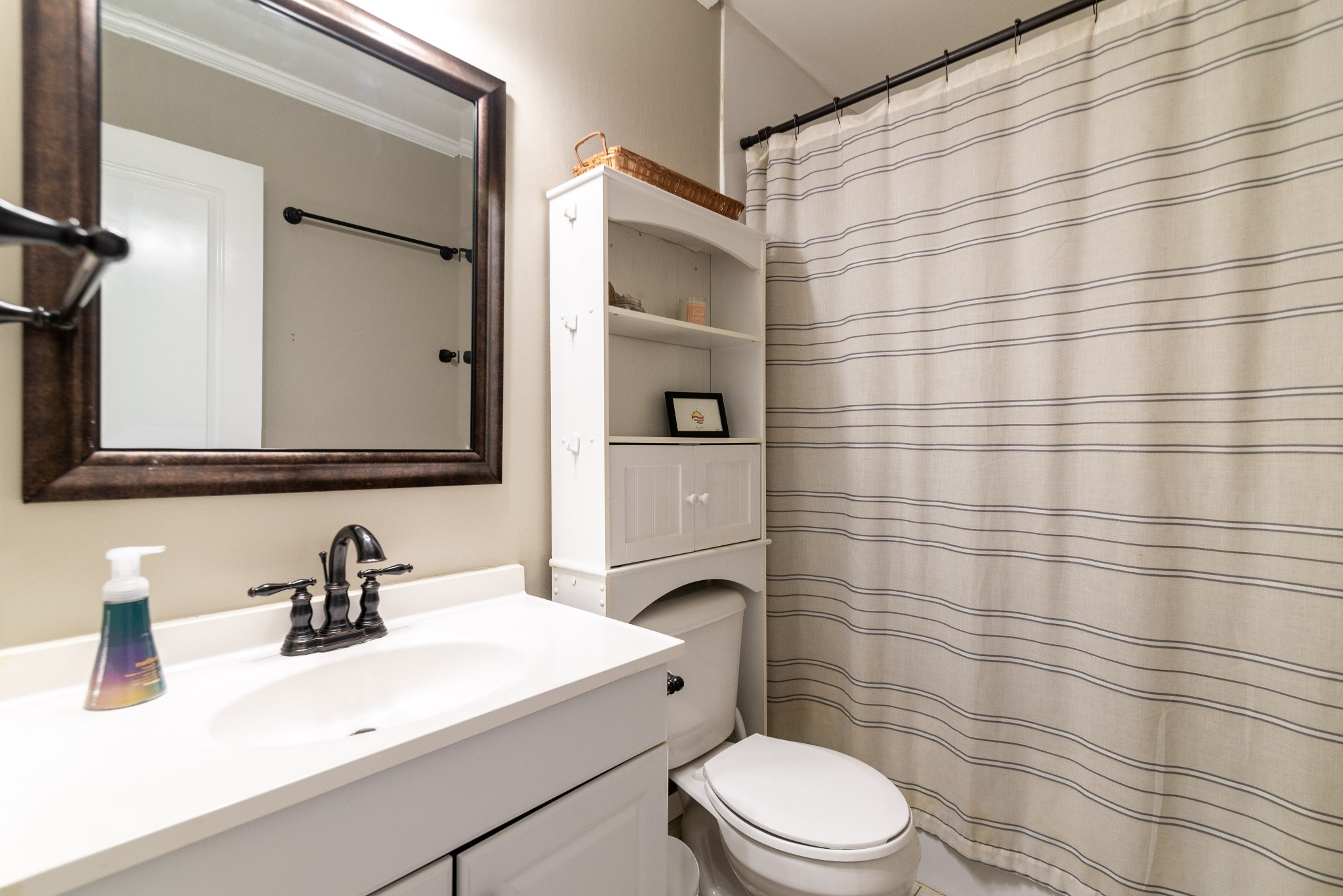 445 Parkside Circle Lebanon, TN 37087 - Photo 18 of 25 a bathroom with a sink a toilet and shower curtain