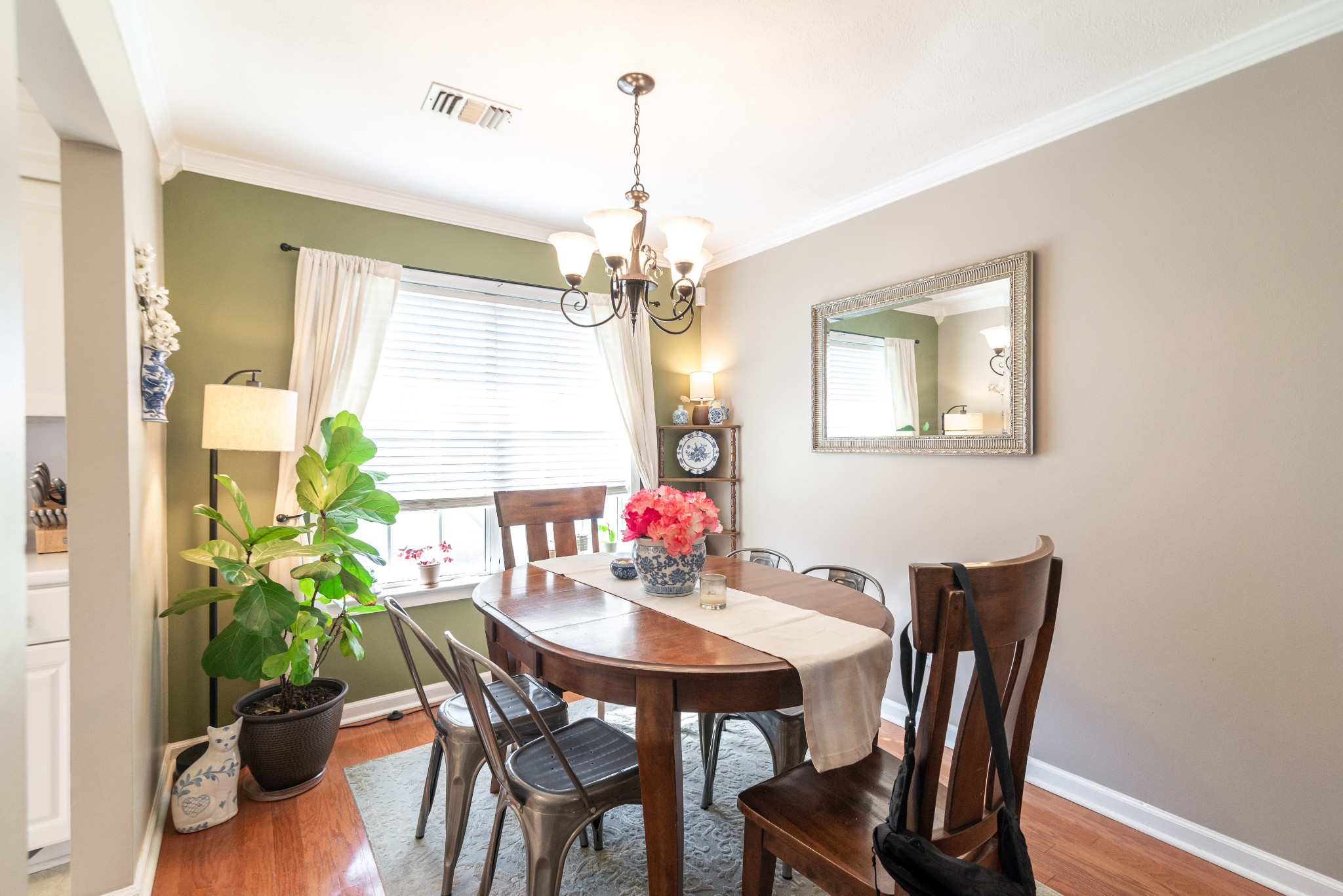 445 Parkside Circle Lebanon, TN 37087 - Photo 10 of 25 a dining room with furniture potted plants and wooden floor