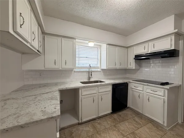 a kitchen with a sink stove and cabinets