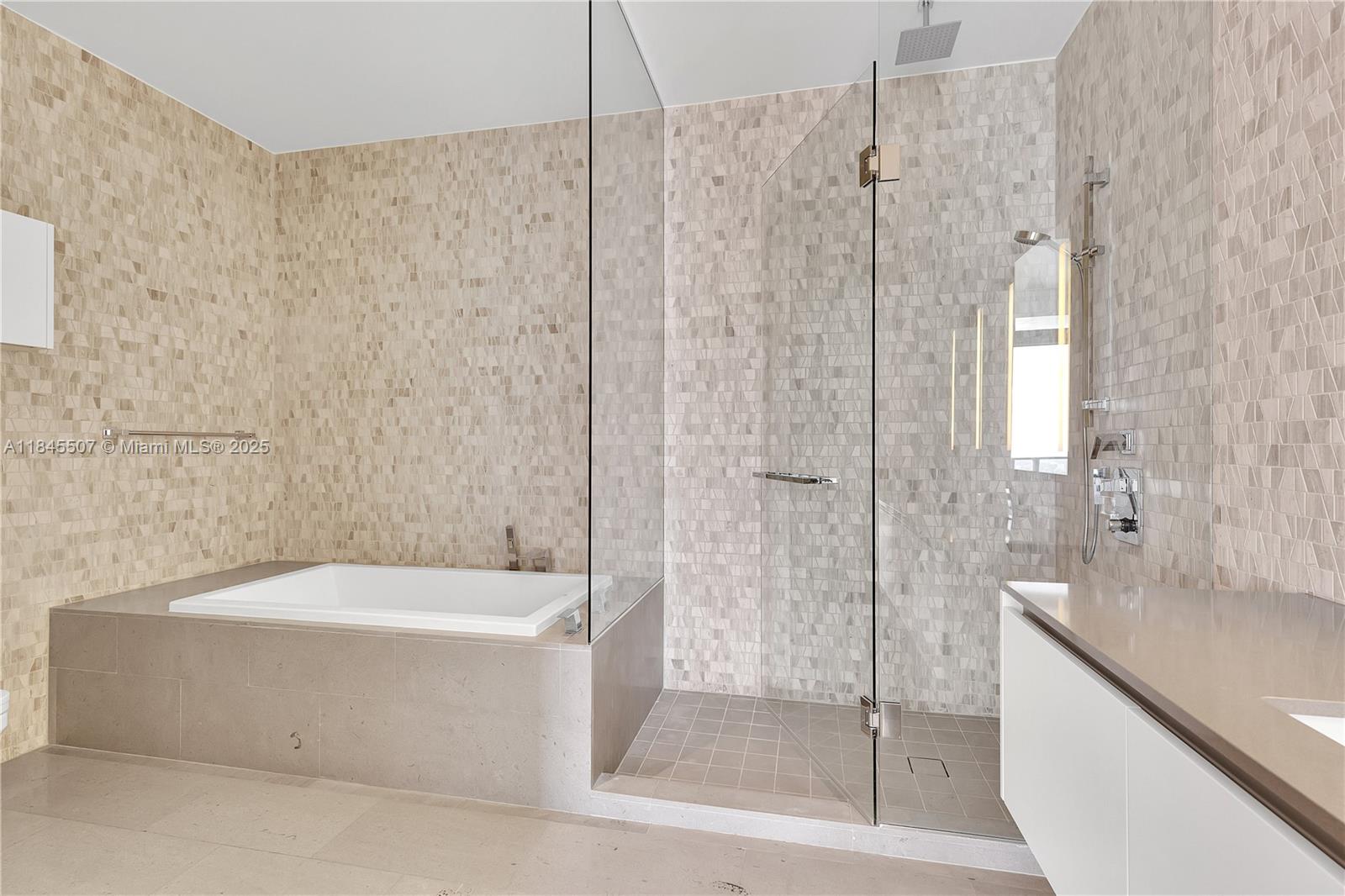 68 Southeast 6th Street, Unit 4110 Miami, FL 33131 - Photo 16 of 23 a bathroom with a bathtub and shower