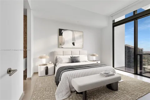 a bedroom with a bed wooden floor and window