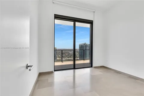 an empty room with sliding glass door and shower