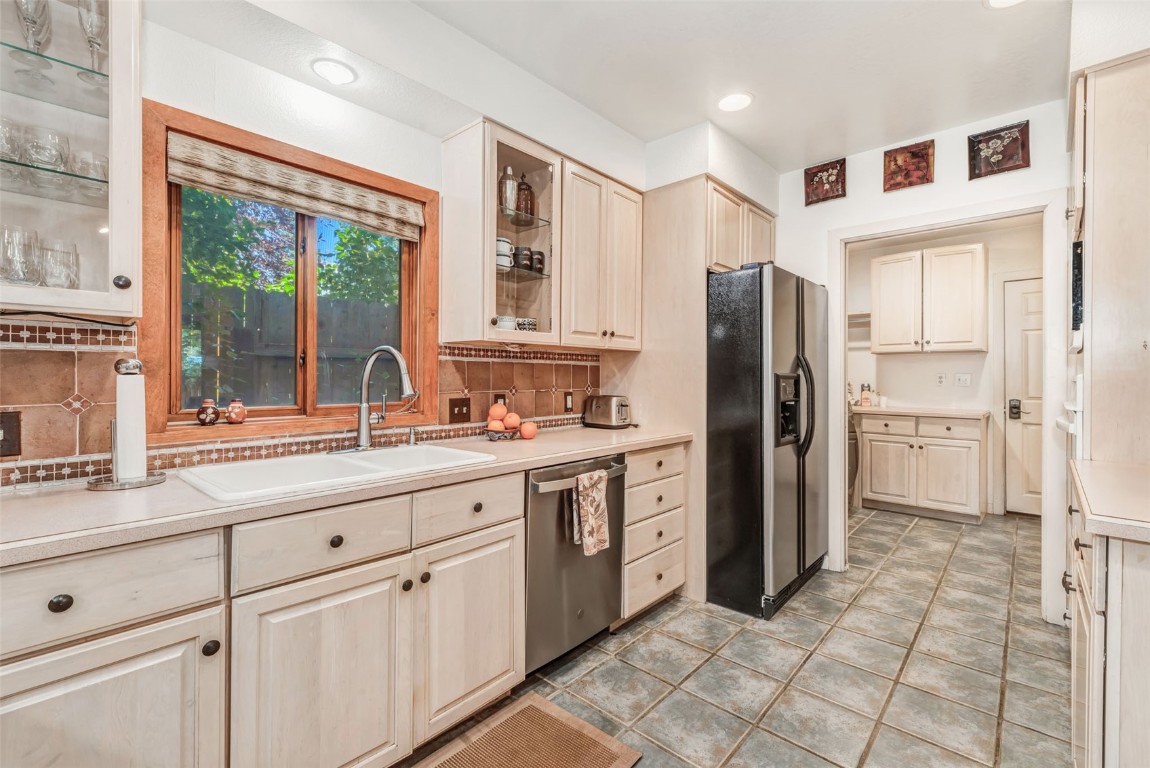 424 3rd Street Steamboat Springs, CO 80487 - Photo 11 of 48 a kitchen with stainless steel appliances a refrigerator sink and cabinets