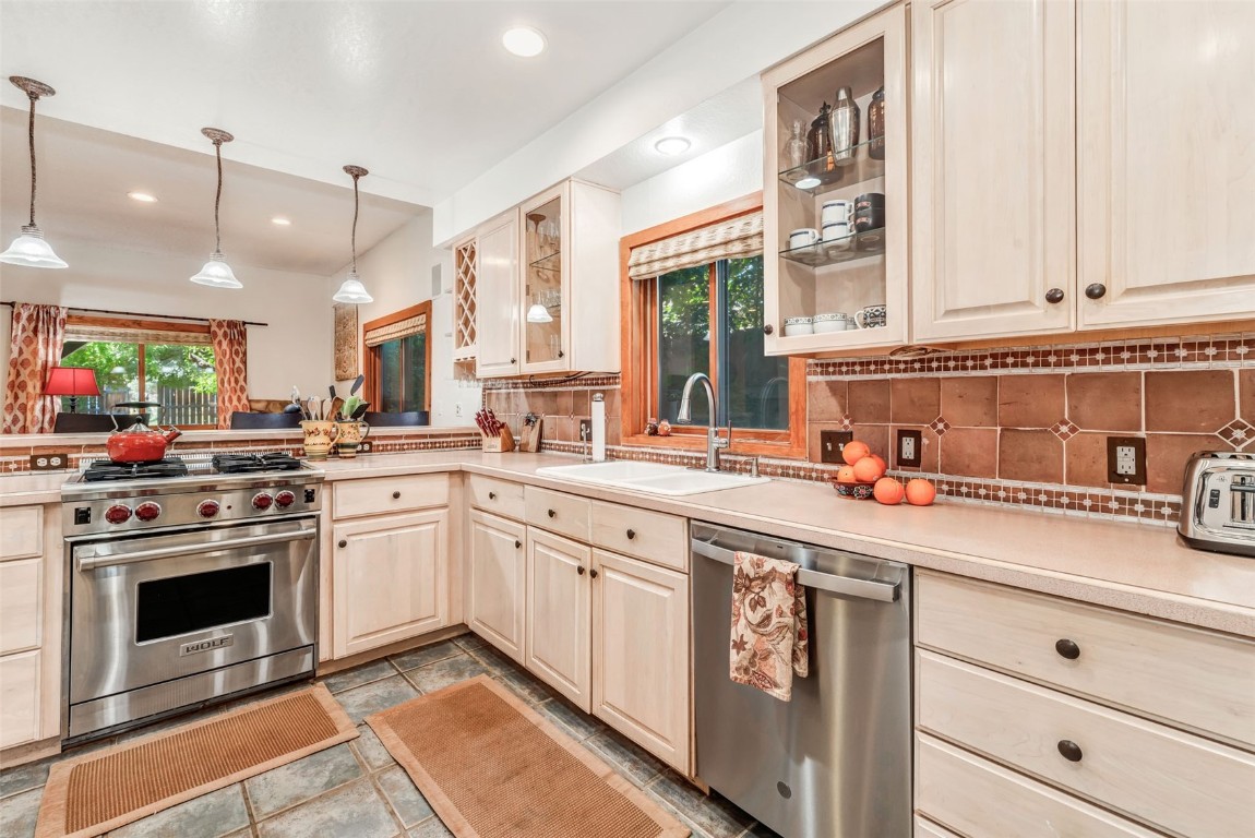 424 3rd Street Steamboat Springs, CO 80487 - Photo 13 of 48 a kitchen with stainless steel appliances granite countertop a stove sink and cabinets