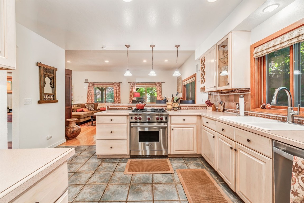 424 3rd Street Steamboat Springs, CO 80487 - Photo 14 of 48 a large white kitchen with stainless steel appliances granite countertop a stove and a sink