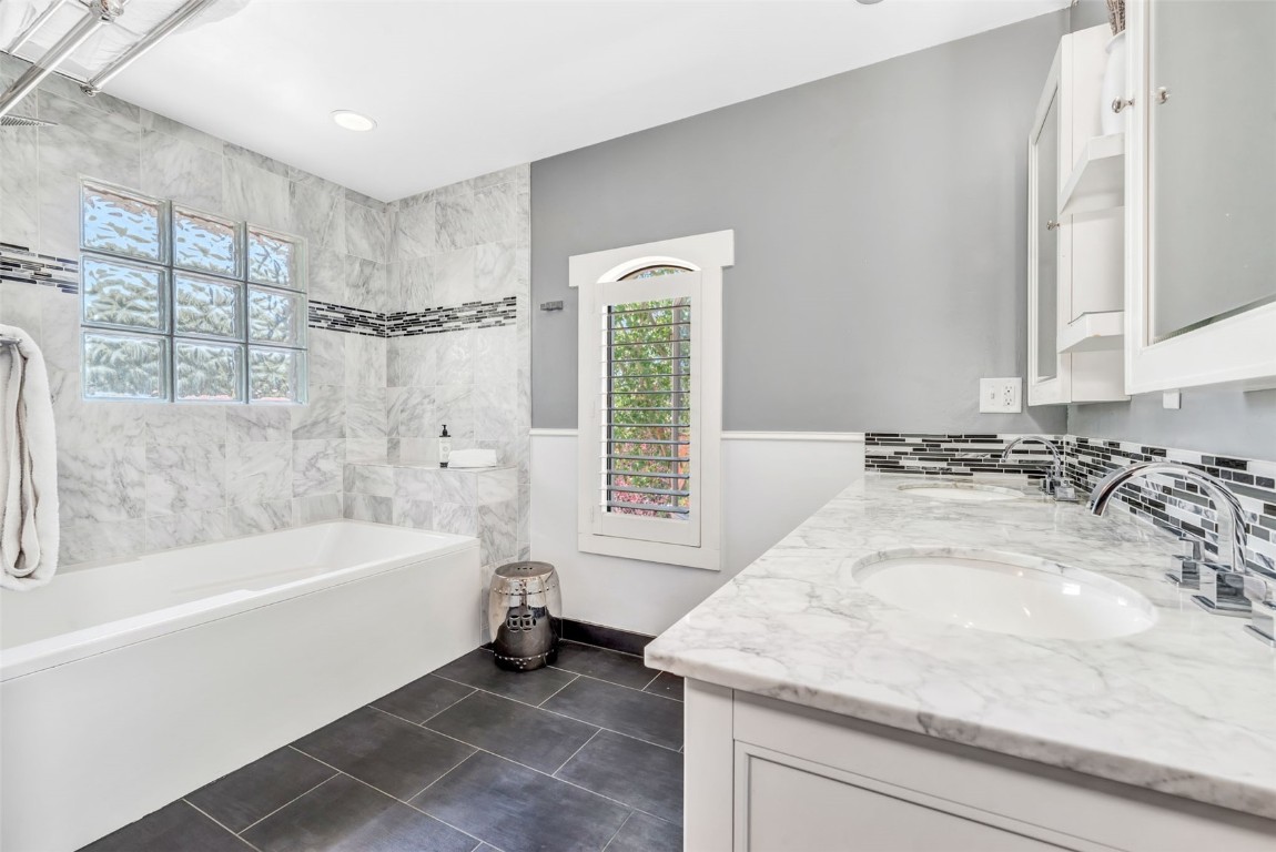 424 3rd Street Steamboat Springs, CO 80487 - Photo 24 of 48 a bathroom with a bathtub a sink a window and a shower