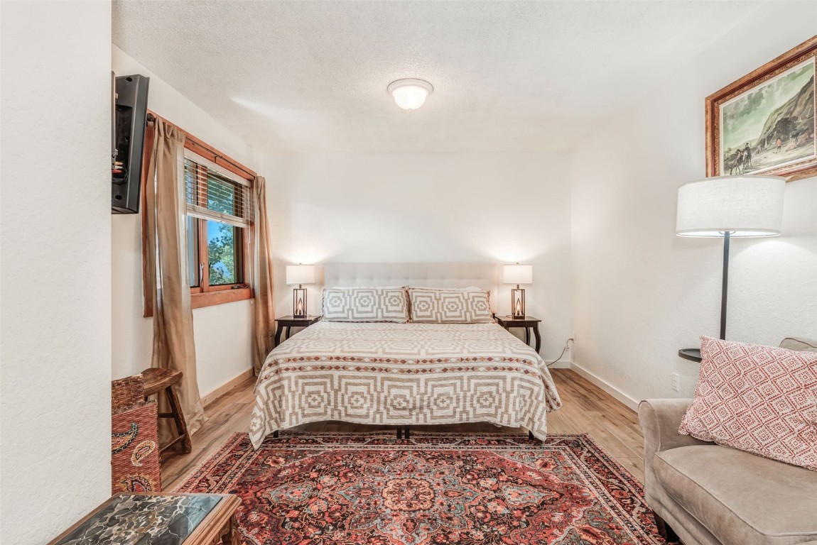 424 3rd Street Steamboat Springs, CO 80487 - Photo 28 of 48 a bedroom with a bed and a lamp with the wooden floor
