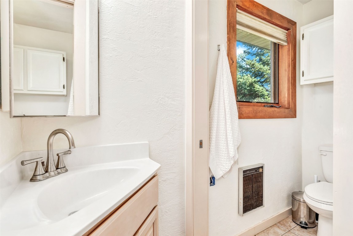 424 3rd Street Steamboat Springs, CO 80487 - Photo 30 of 48 a bathroom with a sink toilet and a mirror