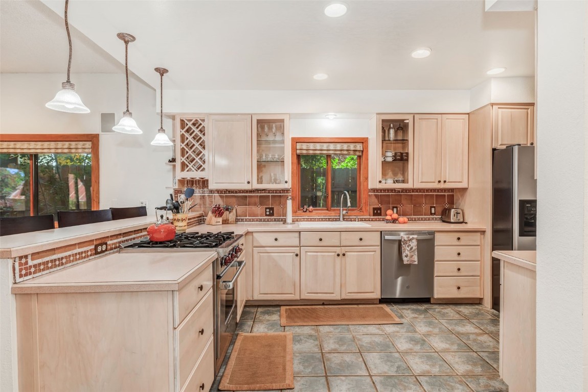 424 3rd Street Steamboat Springs, CO 80487 - Photo 10 of 48 a kitchen with white cabinets and appliances