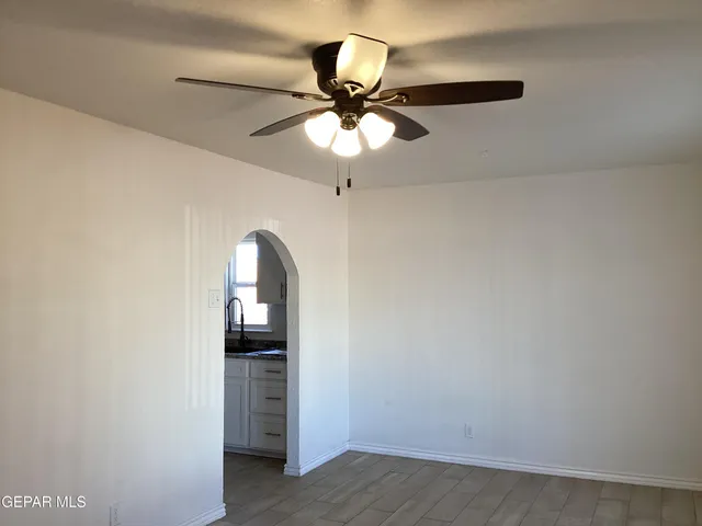a kitchen with granite countertop white cabinets and sink