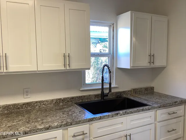 a stove top oven sitting inside of a kitchen