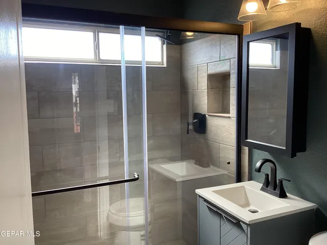 a view of a small space with wooden floor and a window