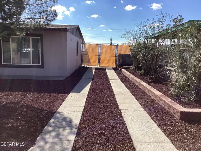 a view of a house next to a yard