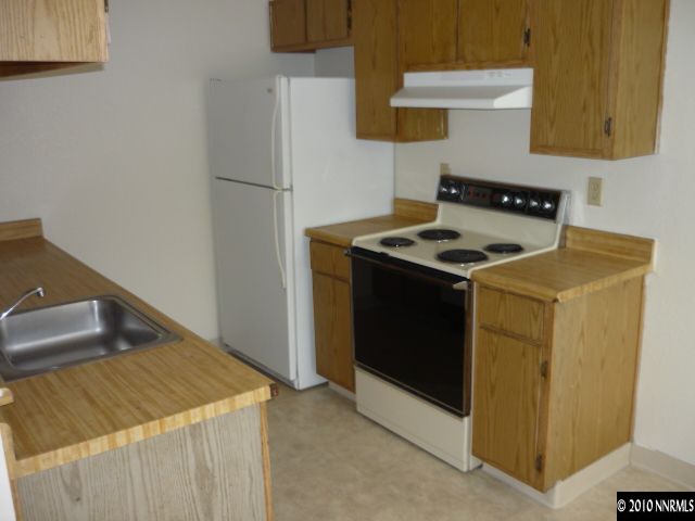 4170 Neil Road, Unit 15S Reno, NV 89502 - Photo 4 of 8 a kitchen stove sitting inside of a kitchen