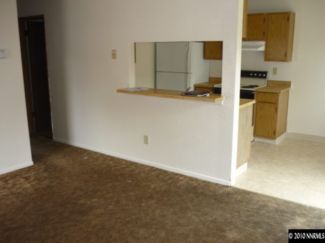 4170 Neil Road, Unit 15S Reno, NV 89502 - Photo 5 of 8 a kitchen with granite countertop a sink a stove top oven a granite counter space and cabinets