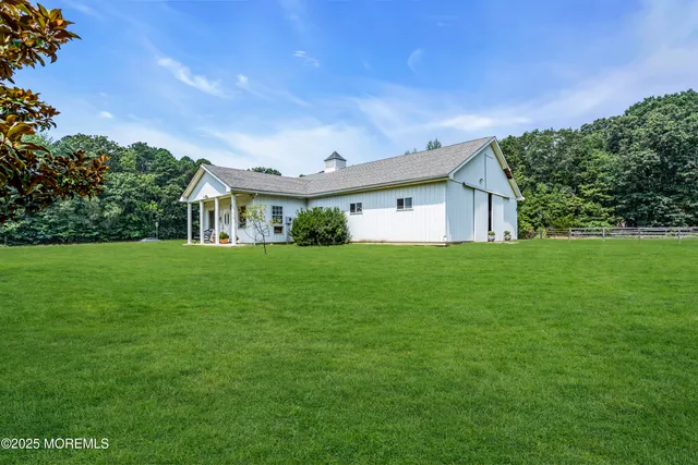a front view of house with yard and green space
