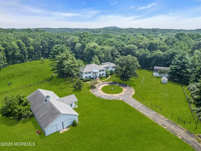 an aerial view of a house with swimming pool big yard and outdoor seating