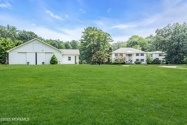 a front view of a house with yard and green space