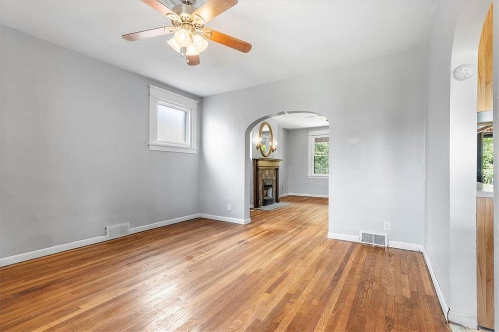1622 Methyl Street Pittsburgh, PA 15216 - Photo 11 of 45 an empty room with wooden floor fan and windows