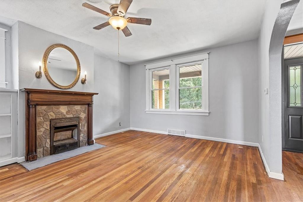 1622 Methyl Street Pittsburgh, PA 15216 - Photo 6 of 45 a view of an empty room with wooden floor fireplace and a window