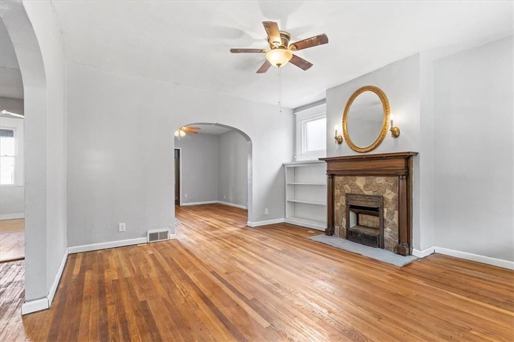 1622 Methyl Street Pittsburgh, PA 15216 - Photo 8 of 45 a view of empty room with wooden floor and fireplace
