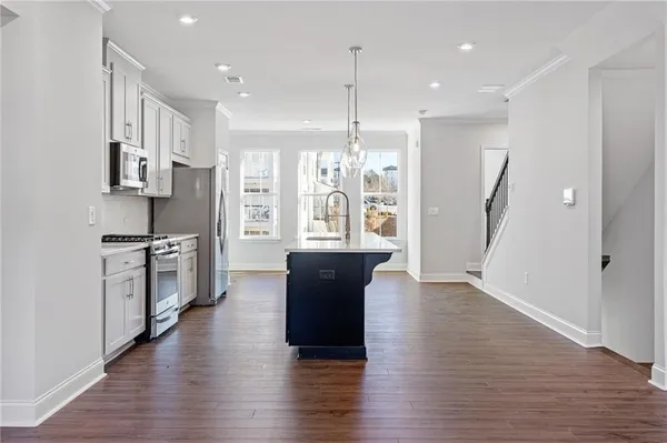 a view of a kitchen with cabinets and wooden floor
