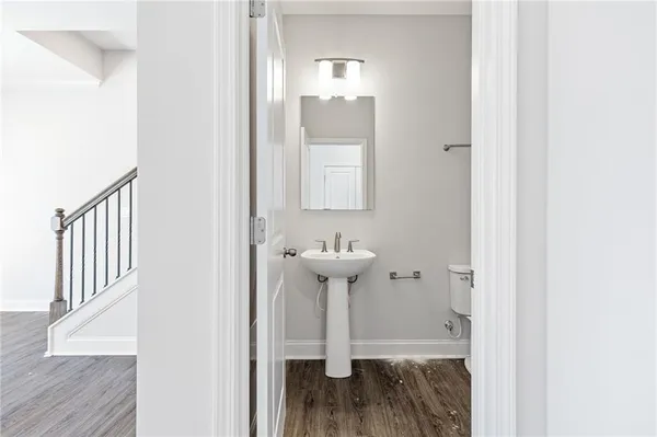a view of a bathroom with sink and wooden floor