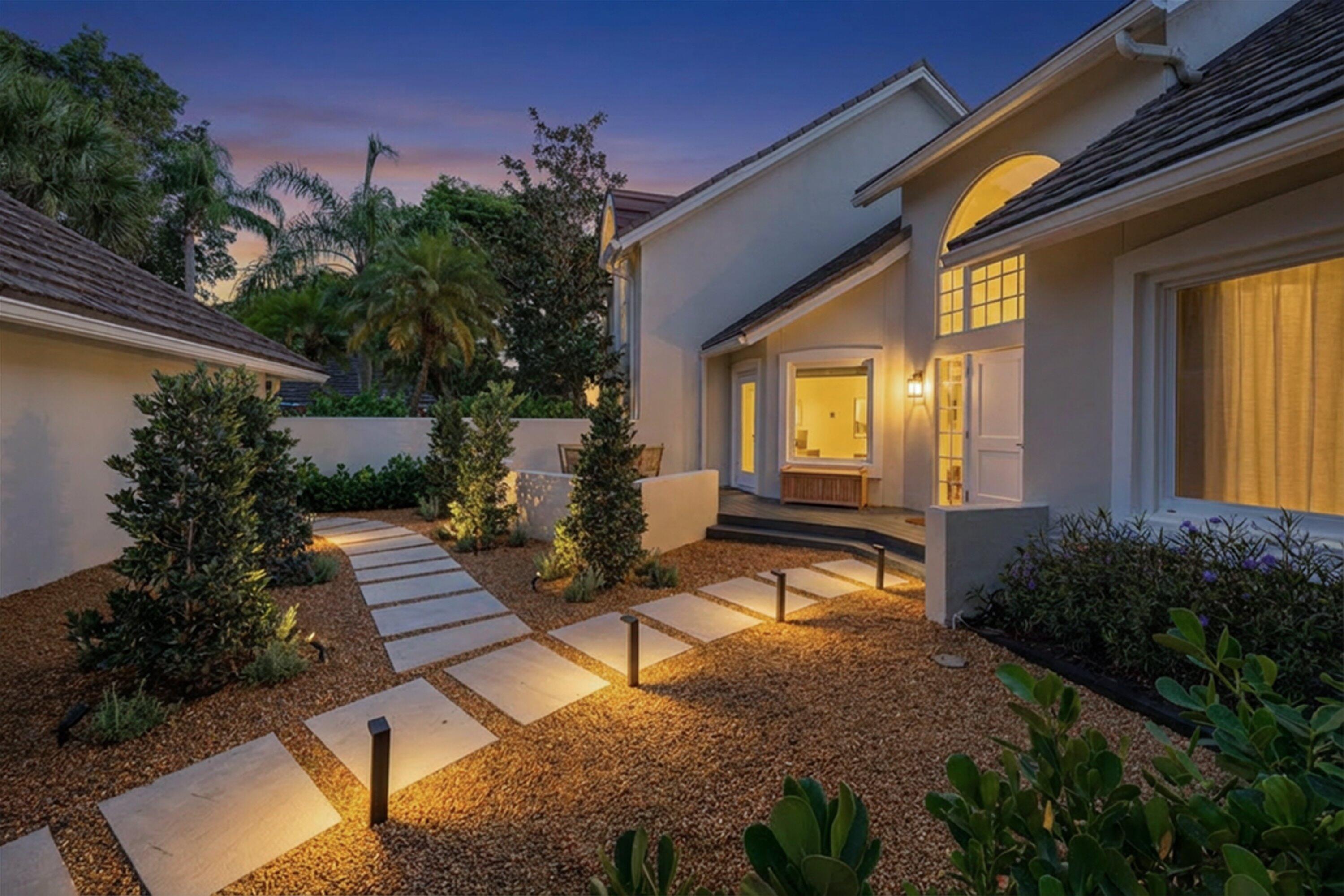 a view of a house with backyard and sitting area