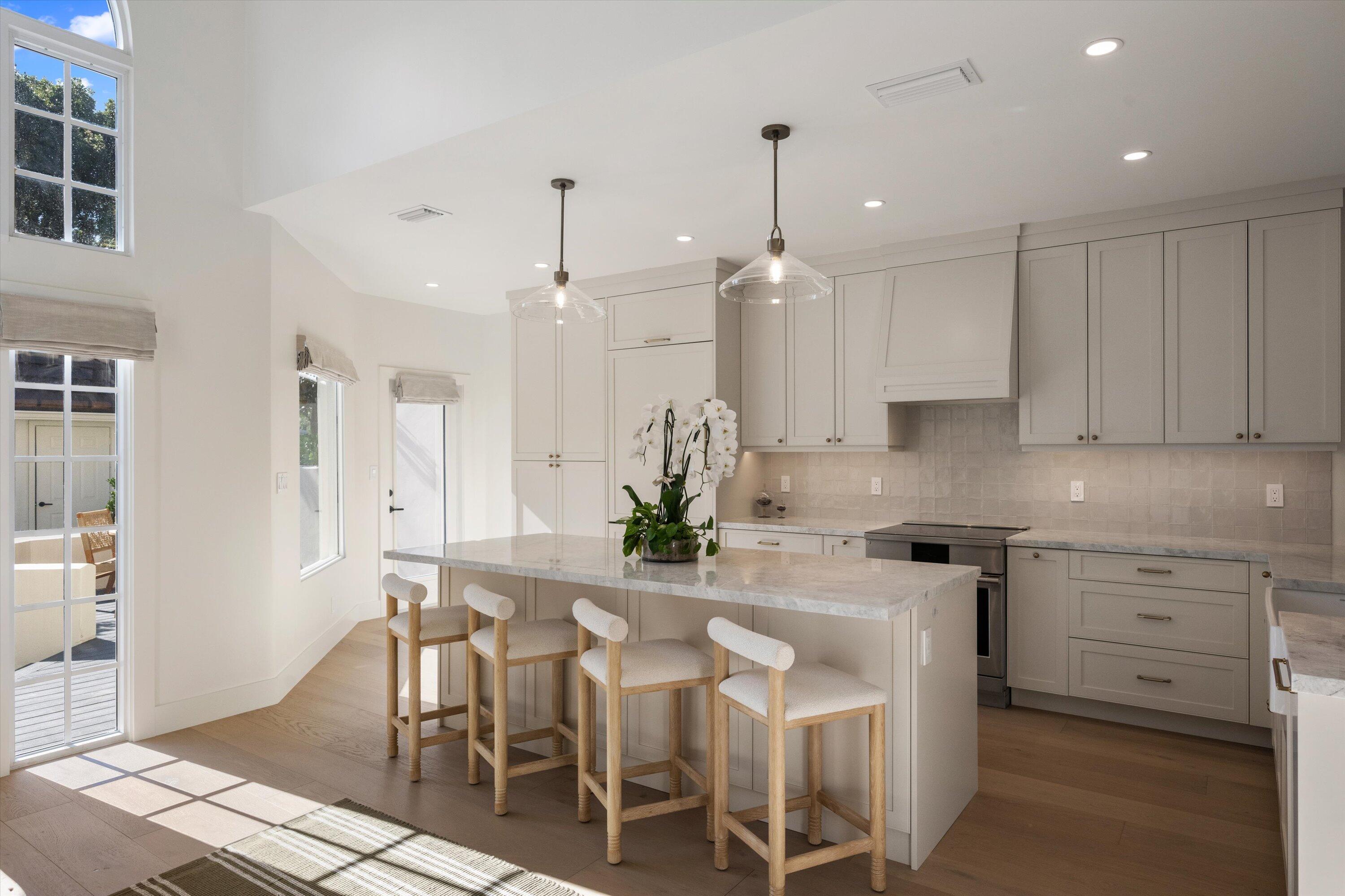 11997 Polo Club Road Wellington, FL 33414 - Photo 2 of 2 a kitchen with stainless steel appliances kitchen island granite countertop a table chairs and a refrigerator
