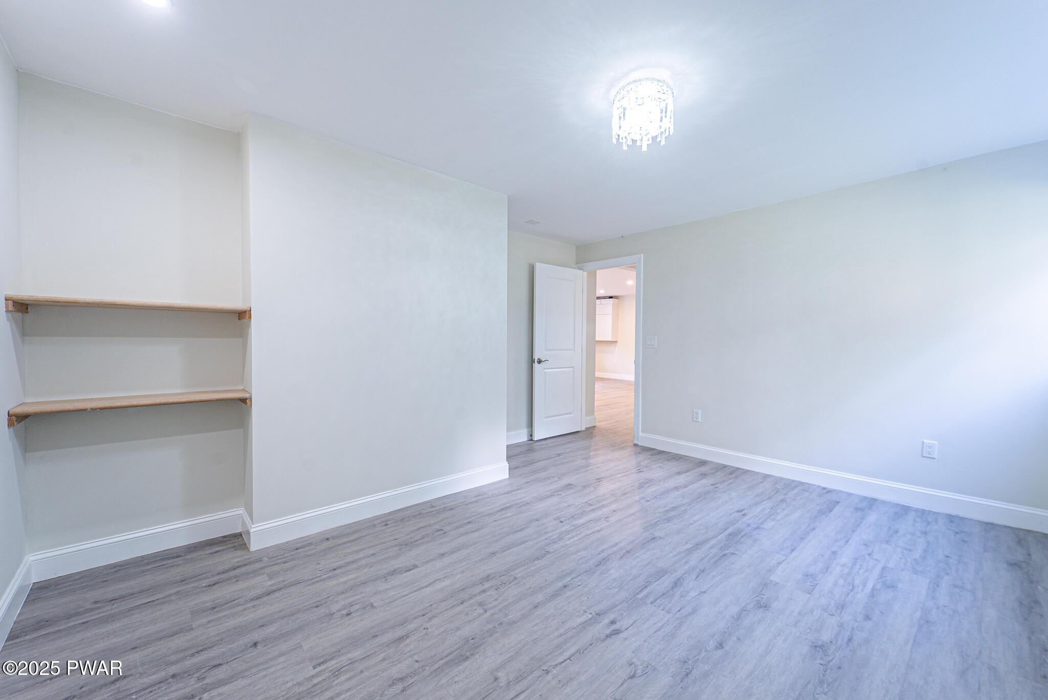 153 Hatton Road Hawley, PA 18428 - Photo 28 of 38 a view of an empty room with wooden floor and a window