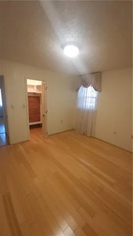 an empty room with windows and entrance