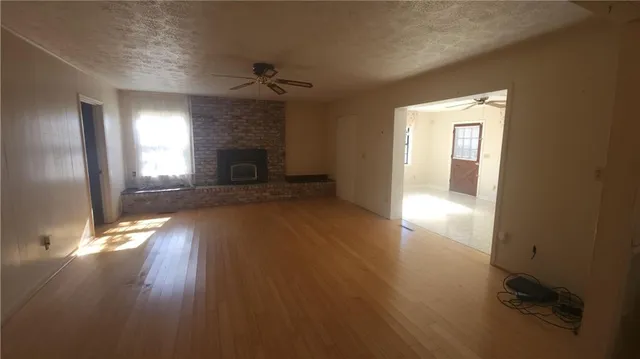 wooden floor in an empty room with a fireplace